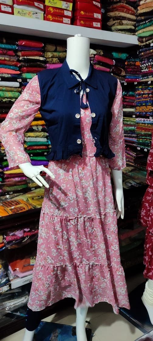 Pink floral tiered midi dress with navy jacket on display